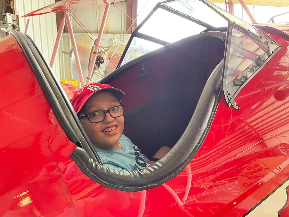 young man smiling from inside the open cockpit of the texaco 17